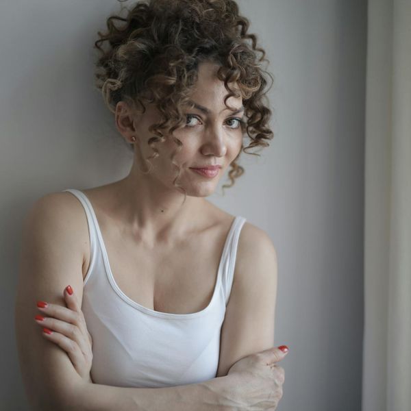 Person smiling peacefully after a gentle exercise session, looking relaxed.